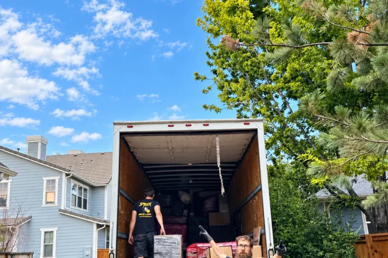 Spyder crew loading a truck in front of a house
