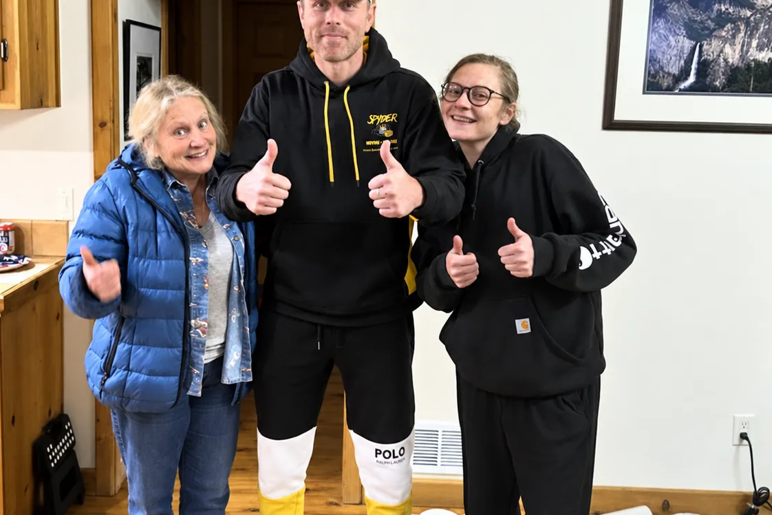 A Spyder crew member with two customers giving a thumbs-up