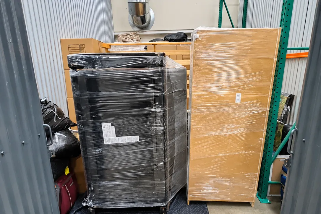 Shrink-wrapped furniture and boxes stored in a Spyder warehouse