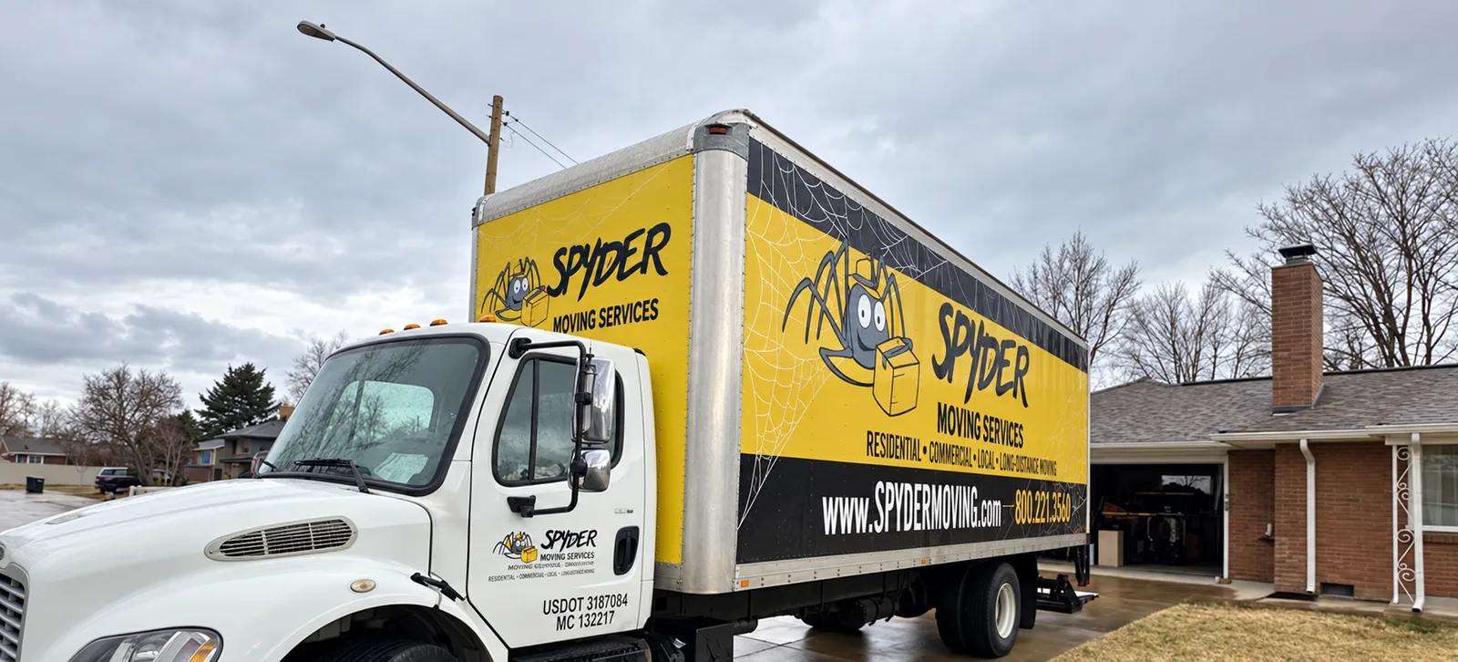 Spyder truck parked in front of a brick house