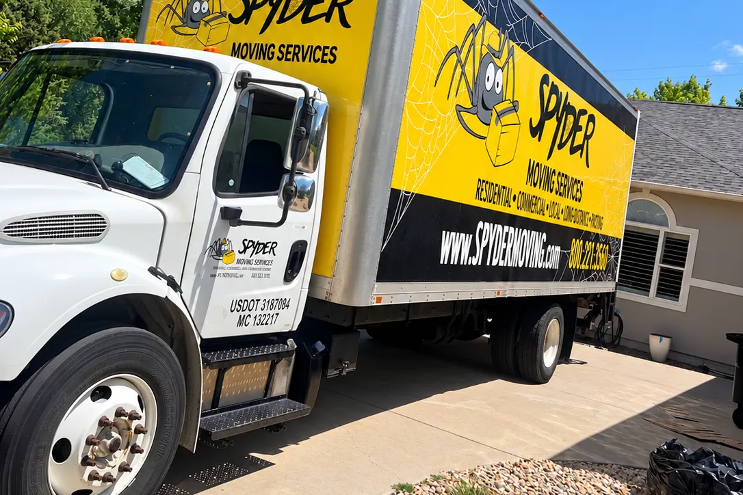 Jackson TN movers from Spyder: a moving truck parked beside a house under shade trees