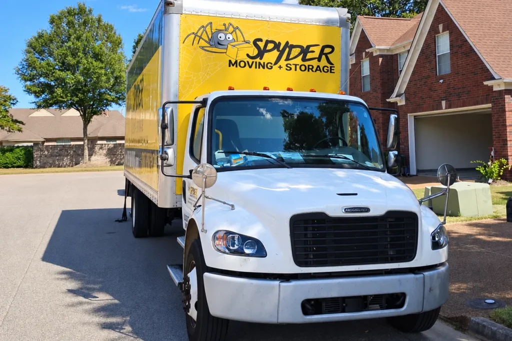 Spyder truck parked in front of a brick house