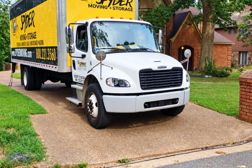 Spyder truck in a driveway next to a lawn