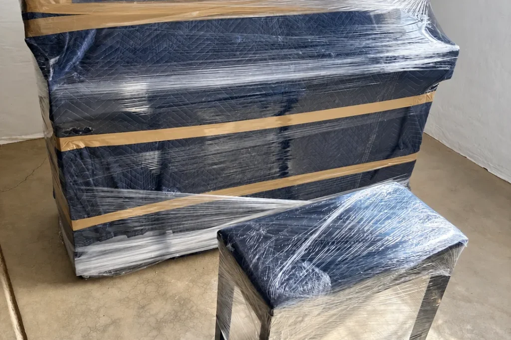 Upright piano and bench wrapped for a move